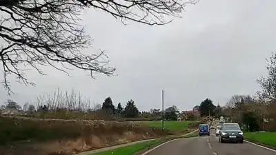 Tractor with Hedge Trimmer Obstructing Road thumbnail