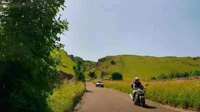 Motorcyclist and Car on Narrow Road thumbnail
